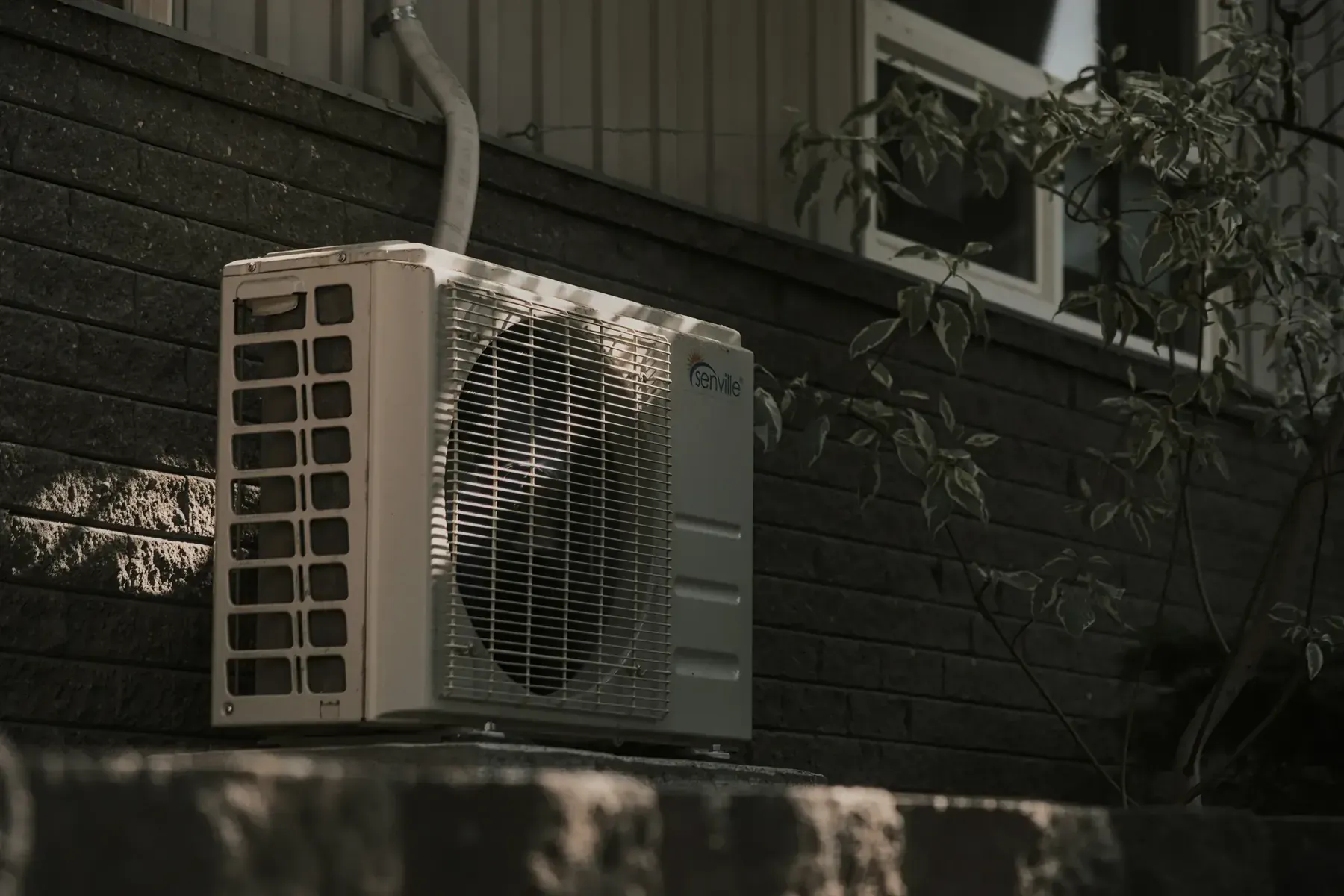Outdoor central air conditioning condenser unit beside a home, the kind of equipment most exposed to Texas Panhandle hail